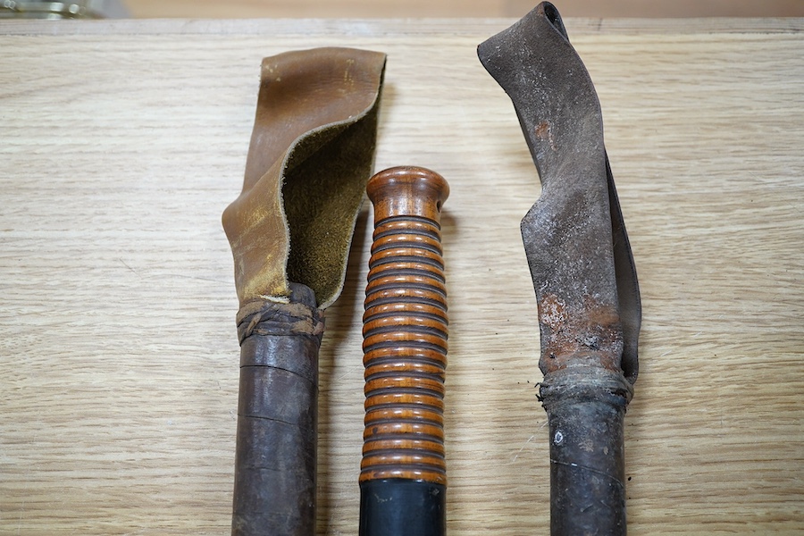 A William IV Victorian overpainted Special Constable truncheon and two bamboo shaft riding crops, largest 46cm. Condition - fair